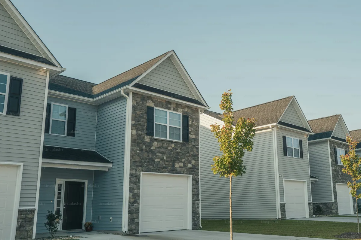 Low-rise suburban townhomes with individual garages and landscaped space